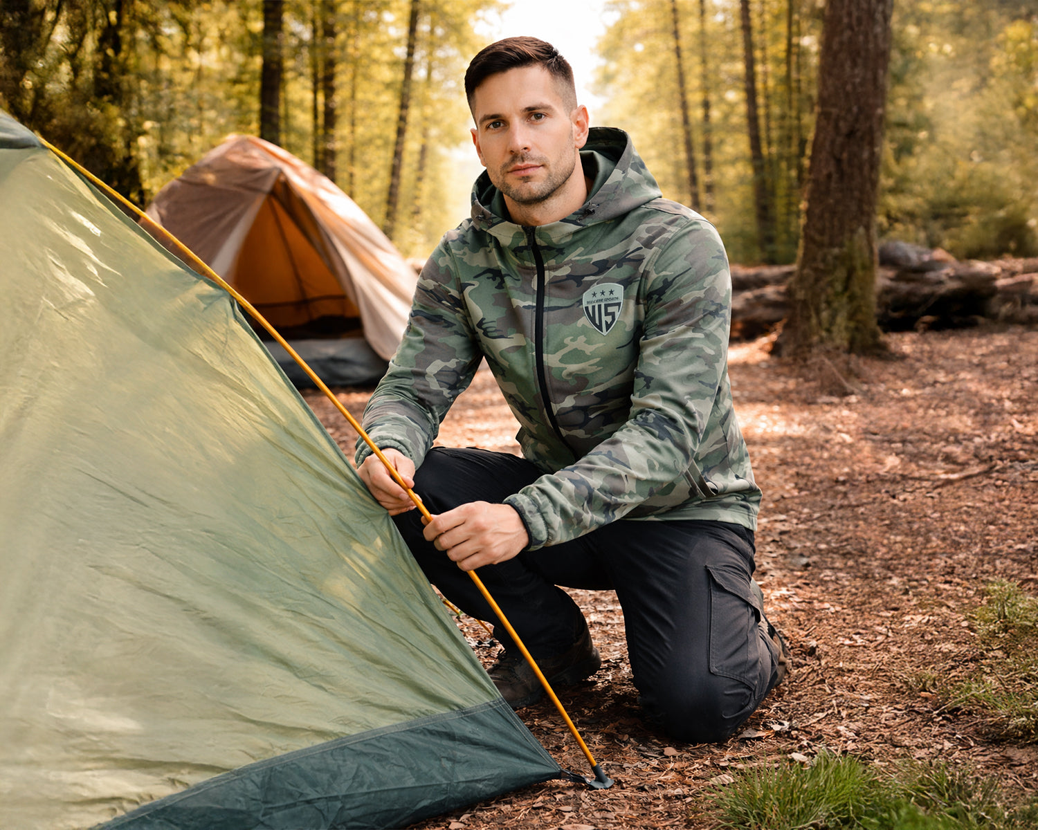 Male model in lightweight camo hooded jacket with modern athletic fit and water-resistant material